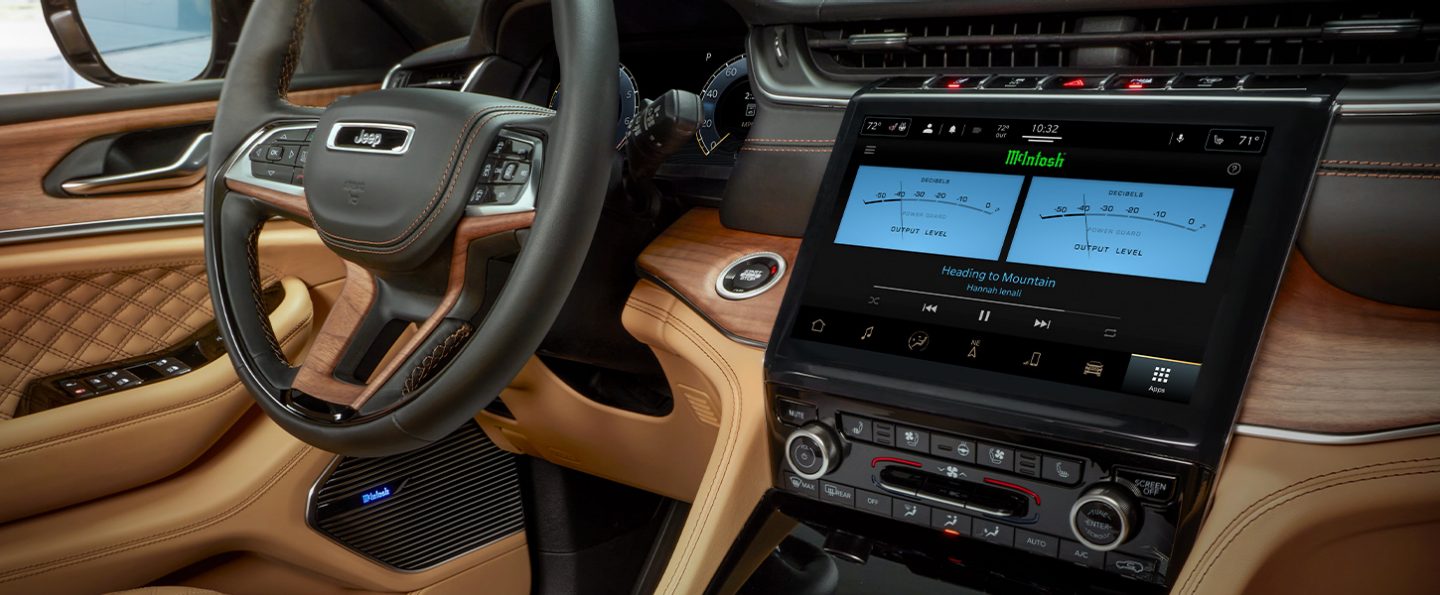The interior of the 2021 Jeep Grand Cherokee L Summit Reserve with the touchscreen displaying power output settings in decibels for the McIntosh speakers.
